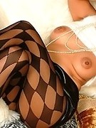 Horny mom in patterned pantyhose and heels touches her breasts and aged pussy tenderly