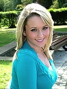 Sexy little blonde in pantyhose showing off her sexy stilettos outdoors