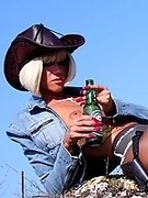 Leggy cowgirl drink beer, smokes cigarette and teases in shiny dark pantyhose and sexy boots